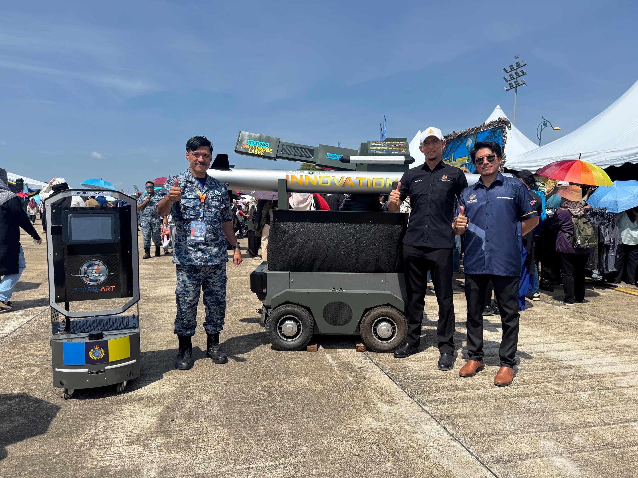 Benua Defence team with Royal Malaysian Air Force officer at defence innovation exhibition